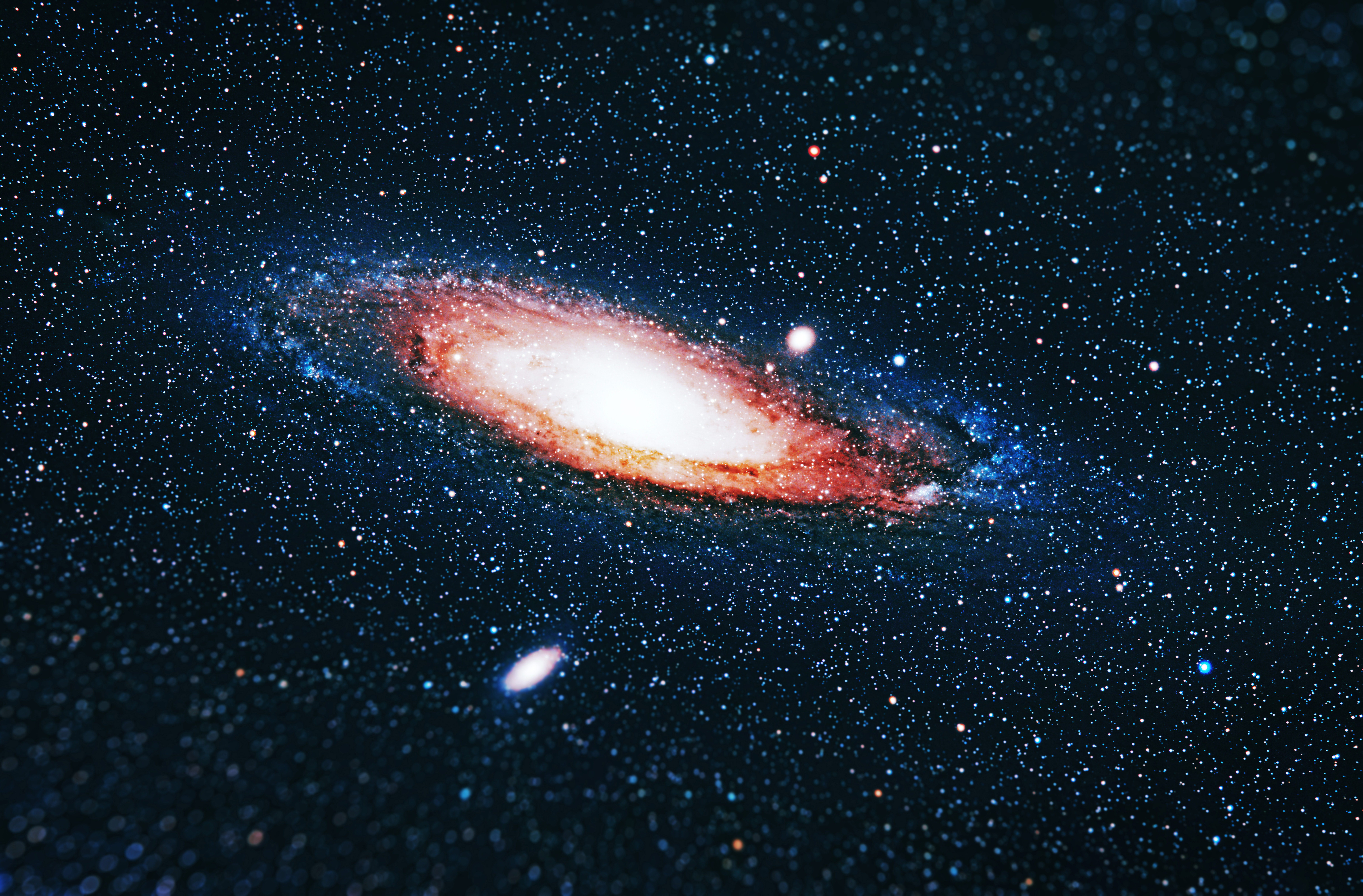 Trendy and beautiful space background with the Andromeda Galaxy (Andromeda Nebula) with tilt-shift blur on the edge of the photo. Stylish horizontal blurred background with Andromeda Nebula for design, website and creative experiments